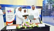 Officials exchanging documents after signing Memorandum of Understanding.