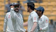 This file photograph taken on March 7, 2017, shows Indian cricket captain Virat Kohli (L) as he celebrates with bowler Umesh Yadav (C) and other teammates after the dismissal of unseen Australian captain Steve Smith during the fourth day of the second Tes