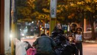 A man and two girls scavenge for food in the streets of Caracas on February 21, 2017. Venezuelan President Nicolas Maduro is resisting opposition efforts to hold a vote on removing him from office. The opposition blames him for an economic crisis that has
