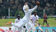 Bangladesh cricketer Soumya Sarkar (R) watches as Sri Lankan cricketer Dinesh Chandimal drops a catch during the fourth day of the opening Test match between Sri Lanka and Bangladesh at the Galle International Cricket Stadium in Galle on March 10, 2017. (