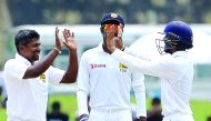 Sri Lankan cricketer Rangana Herath (left) celebrates with his team-mates after he dismissed Bangladesh's Taskin Ahmed during the final day of their opening Test in Galle yesterday. 