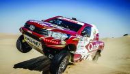 Qatari driver Adel Abdulla of Nissan drives over a sand dune in the Al Qudra desert during the Dubai International Baja.