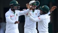 Bangladesh cricketer Soumya Sarkar (C) celebrates with teammates including captain Mushfiqur Rahim (R) after he dismissed unseen Sri Lankan cricketer Dimuth Karunaratne during the fourth day of the second and final Test cricket match between Sri Lanka and