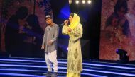 In this photograph taken on March 9, 2017, young Afghan singer Zulala Hashemi (R) stands alongside competitor Sayed Jamal Mubarez as they perform during the television music competition 'Afghan Star' in Kabul. (AFP / Anne CHAON)