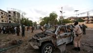 Somali security officers secure the scene of a suicide car explosion in front of the national theatre in Somalia's capital Mogadishu, March 21, 2017 REUTERS/Feisal Omar.