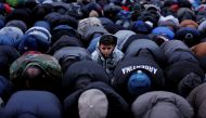 FILE PHOTO - A boy looks up as demonstrators pray while participating in a protest by the Yemeni community against U.S.  REUTERS/Lucas Jackson/File Photo
