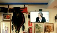 FILE PHOTO: Britain's Prime Minister Theresa May is seen on a television screen next to a mounted bull's head during a prime time news broadcast at a restaurant in Fuengirola, southern Spain, delivering her keynote speech on Brexit at Lancaster House in L