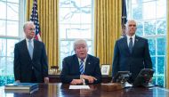 US President Donald Trump, with Vice President Mike Pence (R) and Health and Human Services Secretary Tom Price (L), pauses as he speaks from the Oval Office of the White House in Washington, DC, on March 24, 2017. AFP / MANDEL NGAN