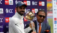 India's Virat Kohli receives the ICC Test Mace from former Indian cricket player Sunil Gavaskar (R) after India won the test series against Australia. (REUTERS/Adnan Abidi)