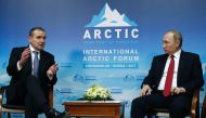 Russian President Vladimir Putin (R) speaks with President of Iceland Gudni Johannesson during the International Arctic Forum in Arkhangelsk on March 30, 2017.  AFP / Sergei Karpukhin