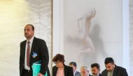 Syria's main opposition High Negotiations Committee (HNC) leader Nasr al-Hariri (L) arrives with his delegation for a press conference following a meeting with the United Nations Special Envoy for Syria during Syria peace talks in Geneva on March 31, 2017