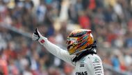 Mercedes driver Lewis Hamilton of Britain reacts after setting pole position in qualifying at the Shanghai International Circuit. REUTERS/Aly Song
