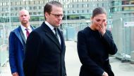 Crown Princess Victoria of Sweden and Prince Daniel react after laying down flowers at a fence near the department store Ahlens in Stockholm, yesterday. 