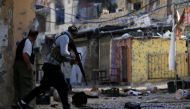 A Palestinian Fatah gunman carries his weapon and he attempts to cross a street at the Ain el-Hilweh refugee camp near Sidon, southern Lebanon April 10, 2017. REUTERS/Ali Hashisho
