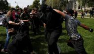 Conservative demonstrators and protesters against U.S. President Donald Trump fight during a Patriots Day Free Speech Rally in Berkeley, California, U.S., April 15, 2017. REUTERS/Stephen Lam