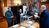 People cast their ballots at a polling station in Le Touquet, northern France, on April 23, 2017, during the first round of the Presidential elections. / AFP / Eric FEFERBERG
