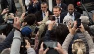 French presidential election candidate for the En Marche! movement, Emmanuel Macron (Rear C-R) meets with supporters outside his house after voting in Le Touquet, northern France, on April 23, 2017, during the first round of the presidential election. AFP