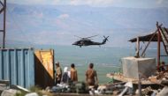 A medical helicopter, from the US-led coalition, flies over the site of Turkish airstrikes near northeastern Syrian Kurdish town of Derik, known as al-Malikiyah in Arabic, on April 25, 2017. AFP / Delil Souleiman
