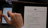 A reporter shoots a picture of a White House press release on its tax reform plan during the daily briefing at the White House in Washington, U.S., April 26, 2017. REUTERS/Carlos Barria