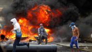 FILE PHOTO: Demonstrators build a fire barricade on a street during a rally against Venezuela's President Nicolas Maduro in Caracas, Venezuela April 24, 2017. REUTERS/Christian Veron/File Photo