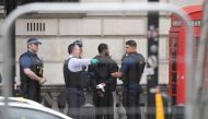 A man is held by police in Westminster after an arrest was made on Whitehall in central London, Britain, April 27, 2017. (REUTERS/Toby Melville)