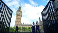 Armed police officers stand guard outside the Houses of Parliament in London 