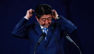 Japan's Prime Minister Shinzo Abe adjusts his headphones during a news conference at a hotel in London, Britain April 29, 2017. REUTERS/Peter Nicholls