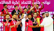Al Rayyan captain receiving the QFA Futsal Cup from QFA Secretary General Mansoor Al Ansari after defeating Al Gharafa in the final at Suheim Bin Hamad Stadium on Monday. 