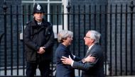 (FILES) This file photo taken on April 26, 2017 shows European Commission President, Jean-Claude Juncker (R) being greeted by British Prime Minister Theresa May outside 10 Downing Street in London on April 26, 2017. AFP / Justin TALLIS