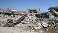 (FILES) This file photo taken on March 26, 2017 shows An Iraqi man amid the rubble of destroyed houses in the Mosul al-Jadida area, following air strikes in which civilians have been reportedly killed during an ongoing offensive against the Islamic State 