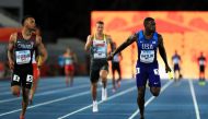(FILES) This file photo taken on April 22, 2017 shows Andre De Grasse of Canada and Justin Gatlin of the USA running to the finishline in heat two of the Men's 4 x 100 Meters Relay during the IAAF/BTC World Relays Bahamas 2017 at Thomas Robinson Stadium i