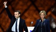 French presidential election candidate for the 'En Marche!' (Onwards!) political movement, Emmanuel Macron (L) greets with his wife Brigitte Trogneux (R) after winning the 2017 French election at the Esplanade du Louvre in Paris, France on May 07, 2017. (