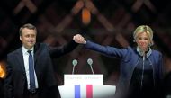French President-elect Emmanuel Macron and his wife Brigitte Trogneux celebrate on the stage at his victory rally near the Louvre in Paris.