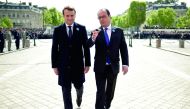 Outgoing French president Francois Hollande (right) and French president-elect Emmanuel Macron talk as they walk during the ceremony marking the 72nd anniversary of the victory over Nazi Germany during WWII on May 8, 1945 under the Arc de Triomphe monumen