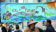 Native American leaders and climate activists prepare to protest outside a Chase Bank location, in opposition to the Keystone XL Pipeline, in Seattle, yesterday.