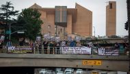 Protesters on an overpass above the 101 freeway denounce the firing of FBI Director James Comey by US President Donald Trump amid investigations into possible collusion between Trump advisors and the Russian government on May 10, 2017 in Los Angeles, Cali