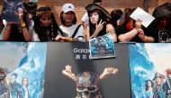 Fans pose for pictures ahead of the red carpet event for the global premiere of the film 