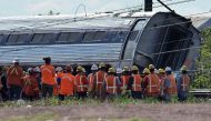 (FILES) This file photo taken on May 13, 2015 shows rescuers gathering around a derailed carriage of an Amtrak train in Philadelphia, Pennsylvania. AFP / JEWEL SAMAD
