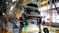 (FILES) This file photo taken on September 30, 2014 shows employees work on the new production plant of the French Renault car maker in Sandouville, northern France.   AFP / CHARLY TRIBALLEAU
