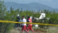Fire brigade crew and health team work near the wreckage of a burned training plane, after it crashed near Radoc town in Mostar, Bosnia and Herzegovina on May 13, 2017. (Zeljko Milicevic / Anadolu Agency)

