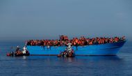 FILE PHOTO: Migrants on a wooden boat are rescued by the Malta-based NGO Migrant Offshore Aid Station (MOAS) in the central Mediterranean in international waters off the coast of Sabratha in Libya, April 15, 2017. REUTERS/Darrin Zammit Lupi/File Photo