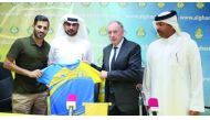 Al Gharafa coach Jean Fernandez (third left) is being presented with a team jersey during a press conference held in the presence of club officials.