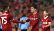 Liverpool's Daniel Sturridge (L) congratulates teammate Roberto Firmino (C) after his goal against Sydney FC during their end-of-season friendly football match at the Olympic Stadium in Sydney on May 24, 2017. AFP / SAEED KHAN