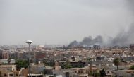 Smoke rises after clashes between National Reconciliation Government of Libya and National Liberation Government in Tripoli, Libya on May 26, 2017. ( Stringer - Anadolu Agency )
