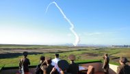 This undated picture released from North Korea's official Korean Central News Agency (KCNA) on May 28, 2017 shows North Korean leader Kim Jong-Un (C-in white shirt) watching the test of a new anti-aircraft guided weapon system organized by the Academy of 