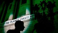 A picture taken on June 2, 2017, shows the City Hall of Barcelona illuminated in green to protest against the announcement by US President Donald Trump on their decision to take the United States out of the Paris climate accord, pledging to meet greenhous