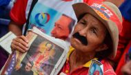 A supporter of Venezuelan President Nicolas Maduro demonstrates against Attorney General Luisa Ortega and her new stance against the government, during in a rally in Caracas, on June 2, 2017.   AFP / LUIS ROBAYO