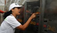 Demonstrator reacts against riot security forces during the 'march of the empty pots' against Venezuelan President Nicolas Maduro's government in Caracas, Venezuela, June 3, 2017. (REUTERS/Marco Bello)