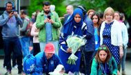 People lay flowers at a pedestrian crossing on the south side of London Bridge, close to Borough Market in London, yesterday.
