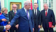 Montenegro Prime Minister Dusko Markovic (centre) shakes hands and is welcomed to Nato during the Deposit of Montenegro's Instrument of Accession to Nato (under Shannon's arm), formally triggering Montenegro's membership in the Nato Alliance, yesterday.
